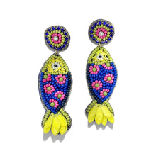 Load image into Gallery viewer, Colorful fish-shaped statement earrings handcrafted with blue beads, pink floral accents, and bright yellow tail details.
