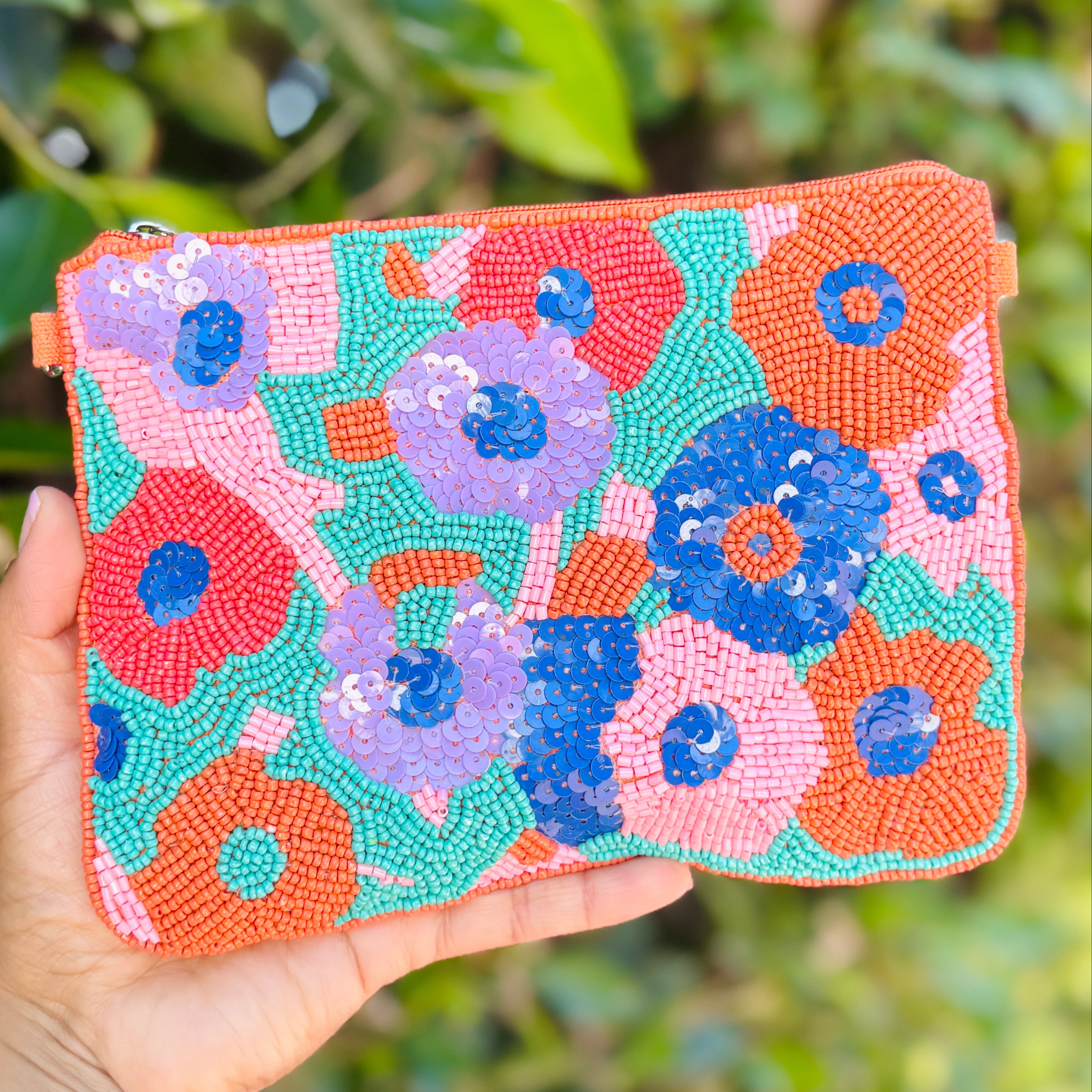Floral beaded zip pouch adorned with bold blooming flowers and bright spring-inspired colors.