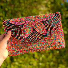 Load image into Gallery viewer, Vibrant statement clutch adorned with multicolored beadwork, showcasing a large floral design against a black background.
