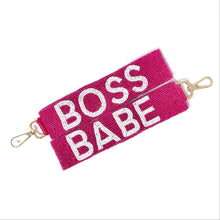 Load image into Gallery viewer, Bright pink strap with white beaded text reading “BOSS BABE” and gold metal clasps at each end. The tone is bold and empowering.