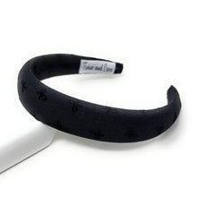 Load image into Gallery viewer, Black headband with bow patterns on a white background