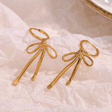 Load image into Gallery viewer, Gold earrings with abstract bow shapes and dangling elements. The design is modern and elegant, suggesting a stylish and artistic flair.