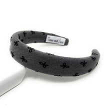 Load image into Gallery viewer, Gray headband with black bow pattern on a white background