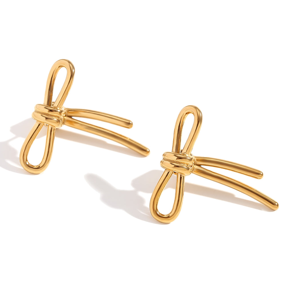 Gold bow-shaped earrings on a white background