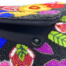Load image into Gallery viewer, Black beaded evening clutch showcasing bright floral patterns in vivid shades of yellow, blue, red, pink, and purple.