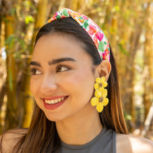 Load image into Gallery viewer, Chic outdoor style showcasing a multicolor floral headband with handcrafted yellow flower earrings and a modern gray top.