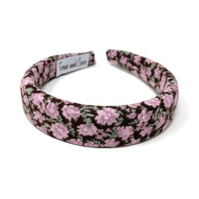 Load image into Gallery viewer, Floral-patterned headband featuring pink and green flowers on a brown background. 