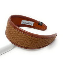 Load image into Gallery viewer, A brown woven headband with a textured design, featuring a smooth inner lining. The headband has a wide band for comfortable wear, conveying a chic and stylish look.