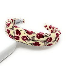 Load image into Gallery viewer, ivory-colored fabric headband with a pattern of burgundy roses and green leaves on a white background. The headband is slightly arched, creating a soft, delicate look.