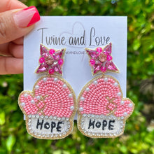 Load image into Gallery viewer, Pink beaded mitten earrings featuring pearl accents, rhinestone trim, and “Hope” embroidery, displayed on a branded jewelry card.