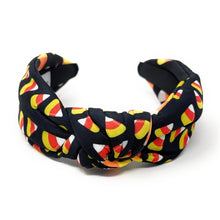Load image into Gallery viewer, A black headband with colorful candy corn print, featuring white, orange, and yellow. Fun, Halloween-themed accessory.
