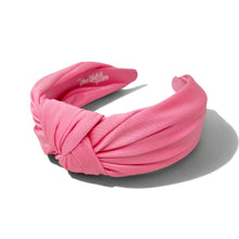 Load image into Gallery viewer, A candy pink color fabric headband with a twisted knot design, photographed on a clean white background with a soft shadow.