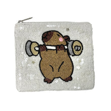 Load image into Gallery viewer, White sequined pouch with a cute capybara lifting weights design.
