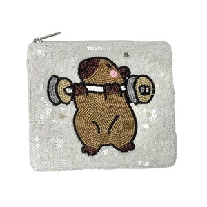 White sequined pouch with a cute capybara lifting weights design.