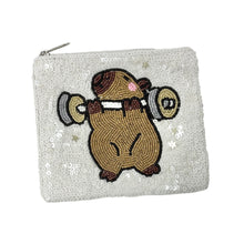 Load image into Gallery viewer, White sequined pouch with a cute capybara lifting weights design.