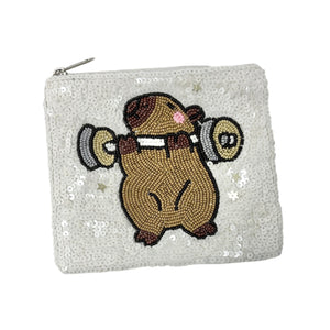 White sequined pouch with a cute capybara lifting weights design.