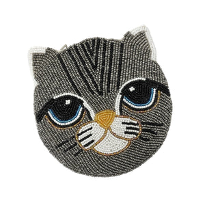 Beaded cat face with large blue eyes and a gray pattern. The intricate design features white ears and nose, and black whisker accents. Cute and whimsical.