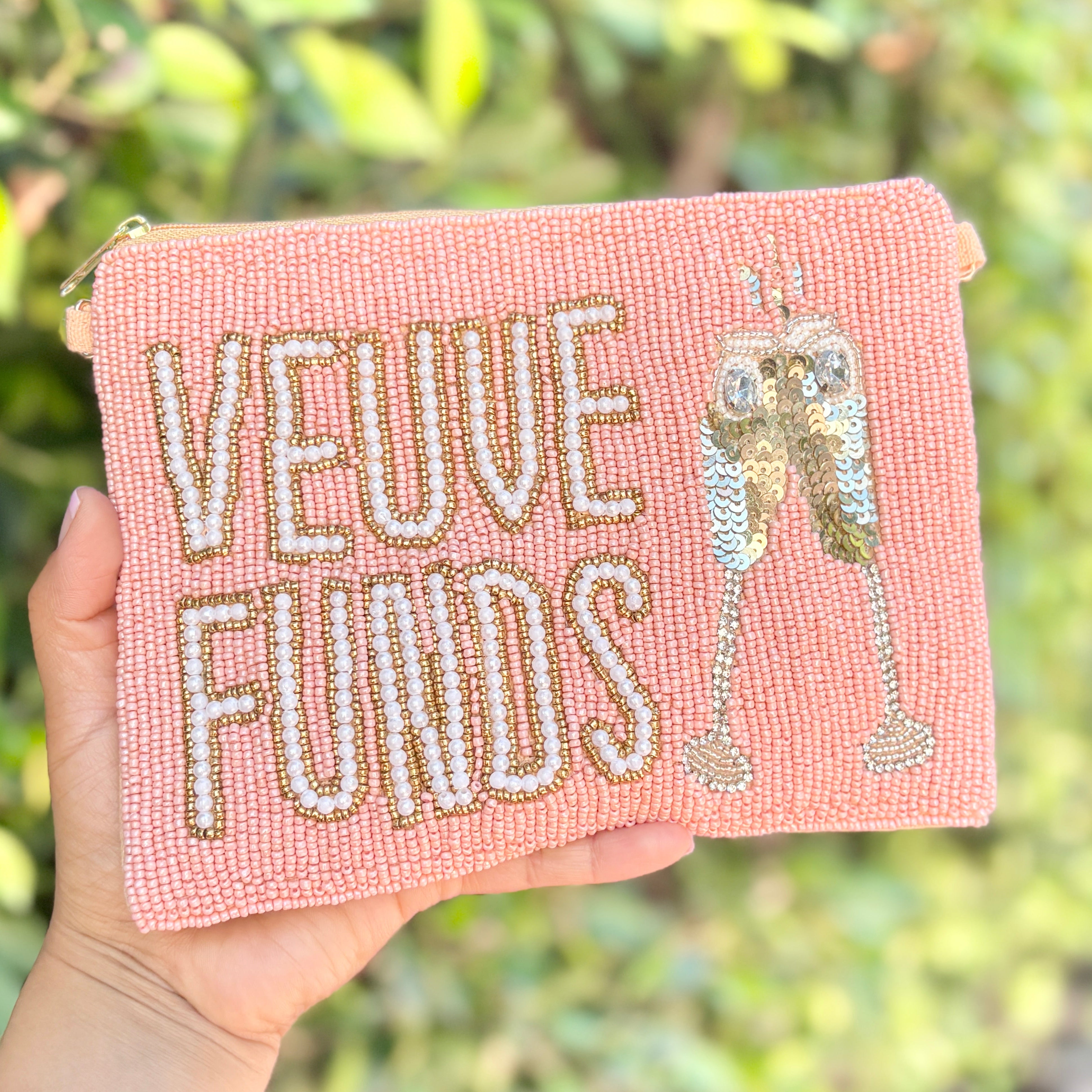 Blush pink beaded pouch with pearl-lettered “Veuve Funds” design and sparkling champagne glass embellishment.
