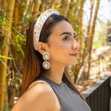Load image into Gallery viewer, Woman wearing a white jeweled headband with sparkling statement earrings and a chic sleeveless top outdoors.