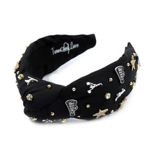Load image into Gallery viewer, Black headband adorned with gold and silver embellishments, including stars, cheerleaders, and rhinestones, exuding a playful and glamorous vibe.