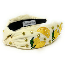 Load image into Gallery viewer, Citrus-inspired fabric headband featuring lemon embroidery, gold embellishments, and a chic twisted knot design.