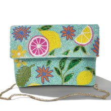 Load image into Gallery viewer, A turquoise beaded clutch bag featuring a colorful embroidered pattern of lemons, limes, flowers, and leaves, with a gold chain strap, shown on a white background with a soft shadow.
