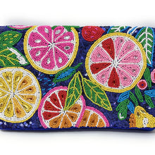 Load image into Gallery viewer, A rectangular beaded clutch purse featuring a vibrant tropical citrus design with pink grapefruit, yellow lemon, and green leaves on a dark blue sequined background, shown against a plain white background.