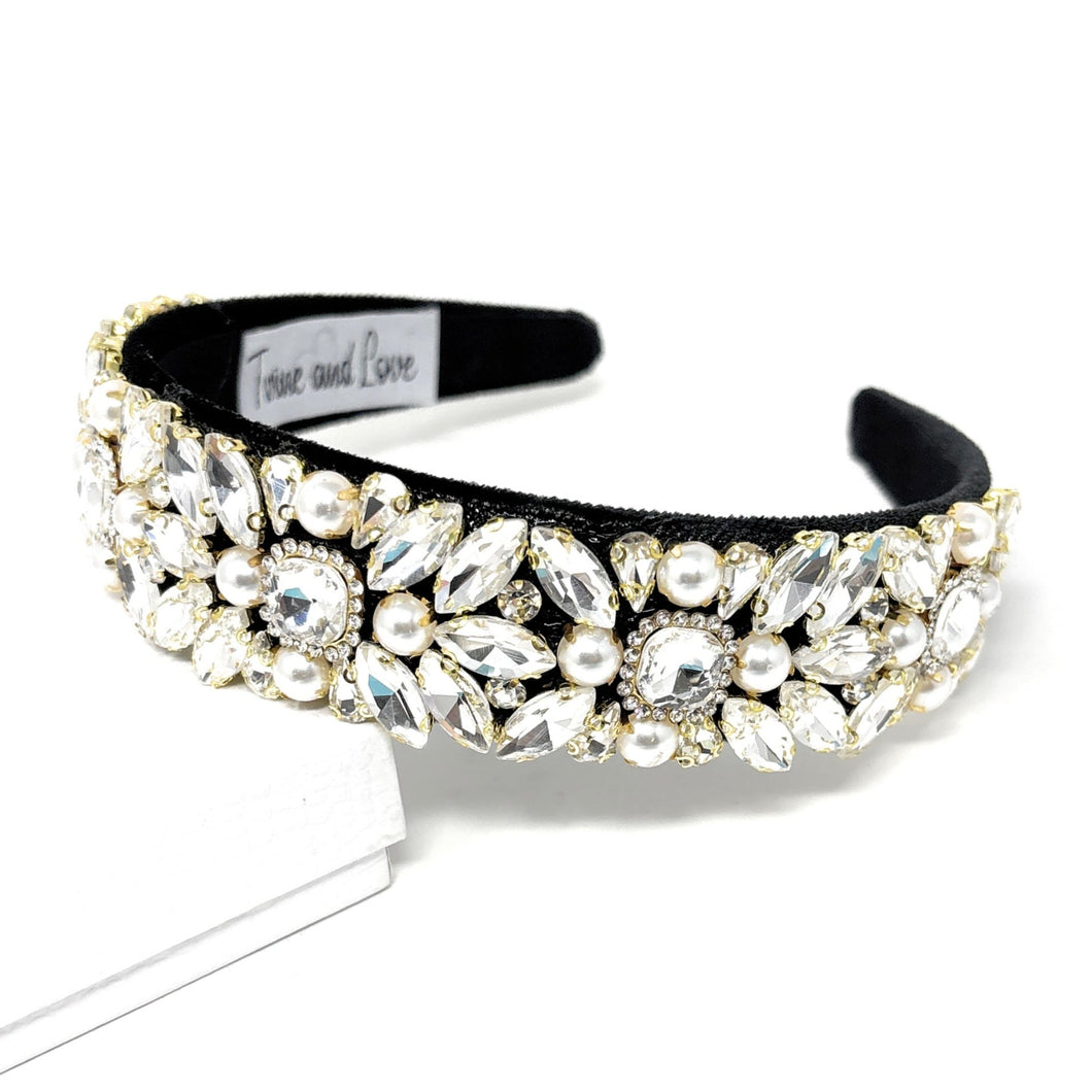 Luxurious black headband adorned with sparkling crystals and pearls in floral patterns, conveying elegance and glamour