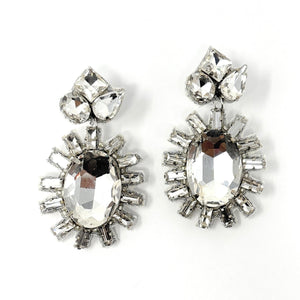 Elegant drop earrings featuring large, oval gemstones surrounded by smaller, radiant crystals on a white background, exuding a glamorous tone.