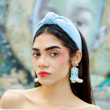Load image into Gallery viewer, Light blue knotted linen headband featuring a wide padded silhouette and elegant front knot detail.
