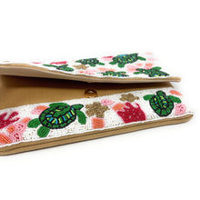 Load image into Gallery viewer, Handmade beaded clutch featuring green turtles and coral pattern