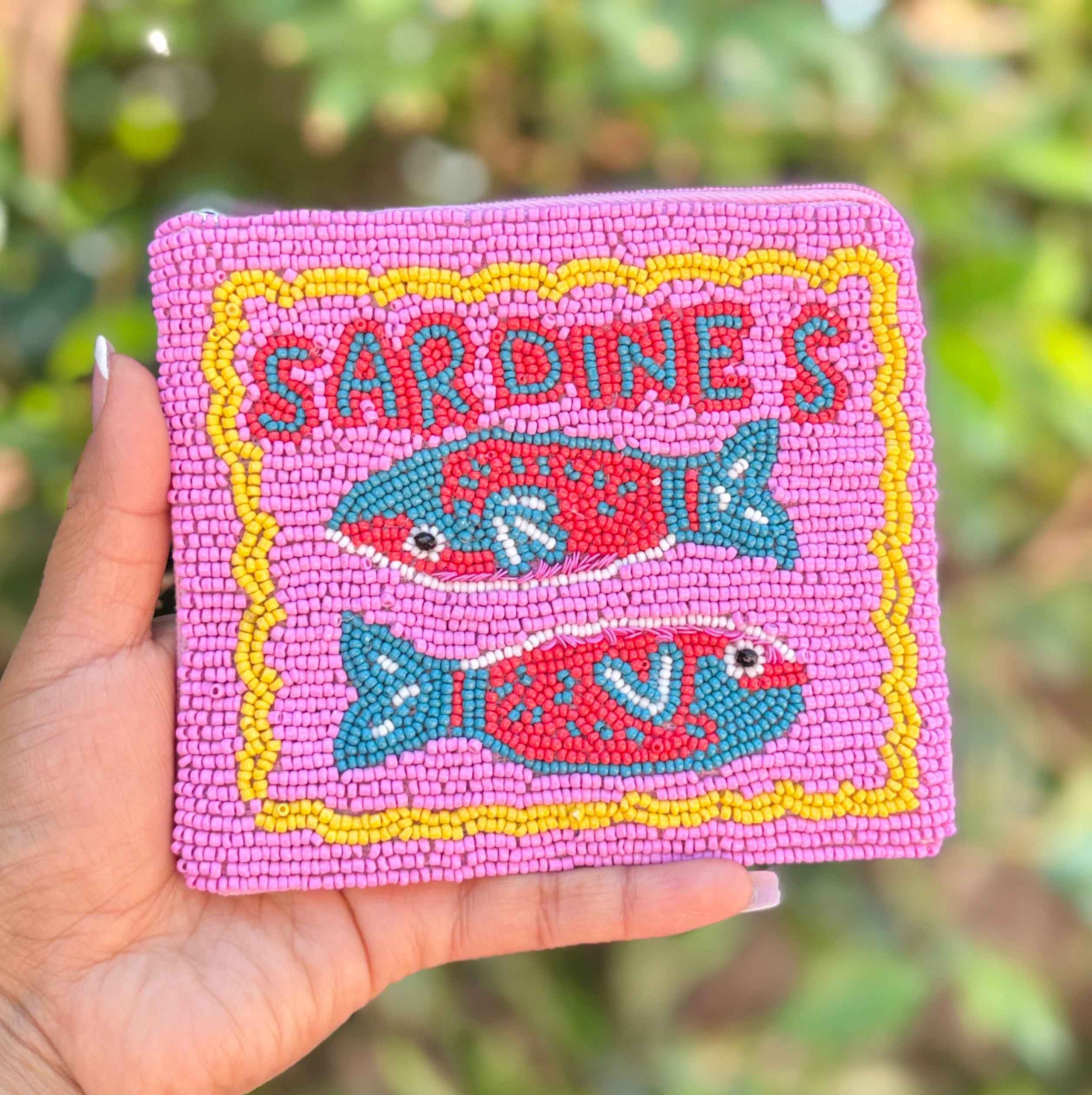 beaded pouch with playful sardines artwork and yellow trim