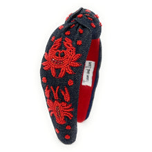 Load image into Gallery viewer, Statement denim knot headband with handcrafted red crab embroidery, textured bead detailing, and seaside charm.
