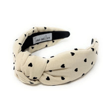 Load image into Gallery viewer, cream headband with black heart patterns on a white background