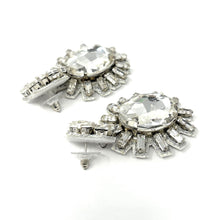 Load image into Gallery viewer, Sparkling crystal statement earrings with silver sunburst design and oversized rhinestone center.