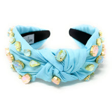 Load image into Gallery viewer, Smiling woman wearing a crystal embellished blue headband paired with colorful tropical parrot statement earrings.