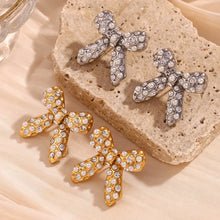 Load image into Gallery viewer, Bow-shaped earrings with rhinestones on a textured surface