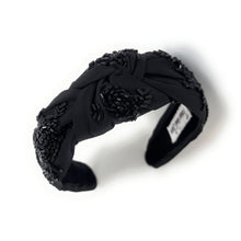 Load image into Gallery viewer, headband featuring black sequin embroidery, dimensional rose accents, and a stylish twisted knot design.