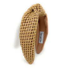 Load image into Gallery viewer, A woven straw headband featuring a twisted knot design, with a soft beige lining. The label inside reads &quot;Time and Love,&quot; set against a white background.