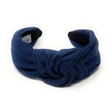 Load image into Gallery viewer, A dark blue denim fabric headband with a centered knot design sits on a white background. The soft texture and simple style convey a casual, elegant tone.