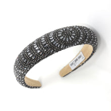 Load image into Gallery viewer, A dark beaded headband with intricate patterns on a white surface. The headband has a textured design and an elegant, luxurious appearance.