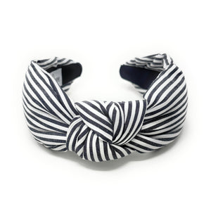 Black and white striped headband on a white background
