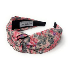 Load image into Gallery viewer, Floral headband with pink, purple, and dark green pattern on a white background. It features a central knot, creating a vibrant, stylish look.