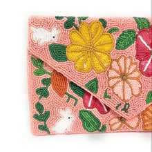 Load image into Gallery viewer, Decorative purse with a pink background and vibrant floral patterns