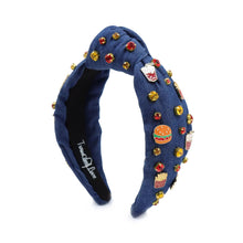 Load image into Gallery viewer, A blue denim headband with a knot design, decorated with red, gold, and clear rhinestones and small enamel fast-food-themed pins, including fries and sodas.
