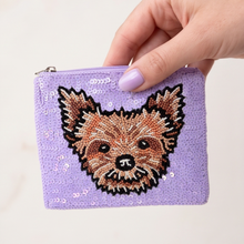 Load image into Gallery viewer, A lavender purple sequin coin purse featuring a detailed beaded dog face design, held by a hand with light purple nail polish against a clean white background.