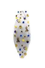 Load image into Gallery viewer, White padded headband with a twisted design, adorned with vibrant blue, yellow gemstones and down syndrome awareness charms. 