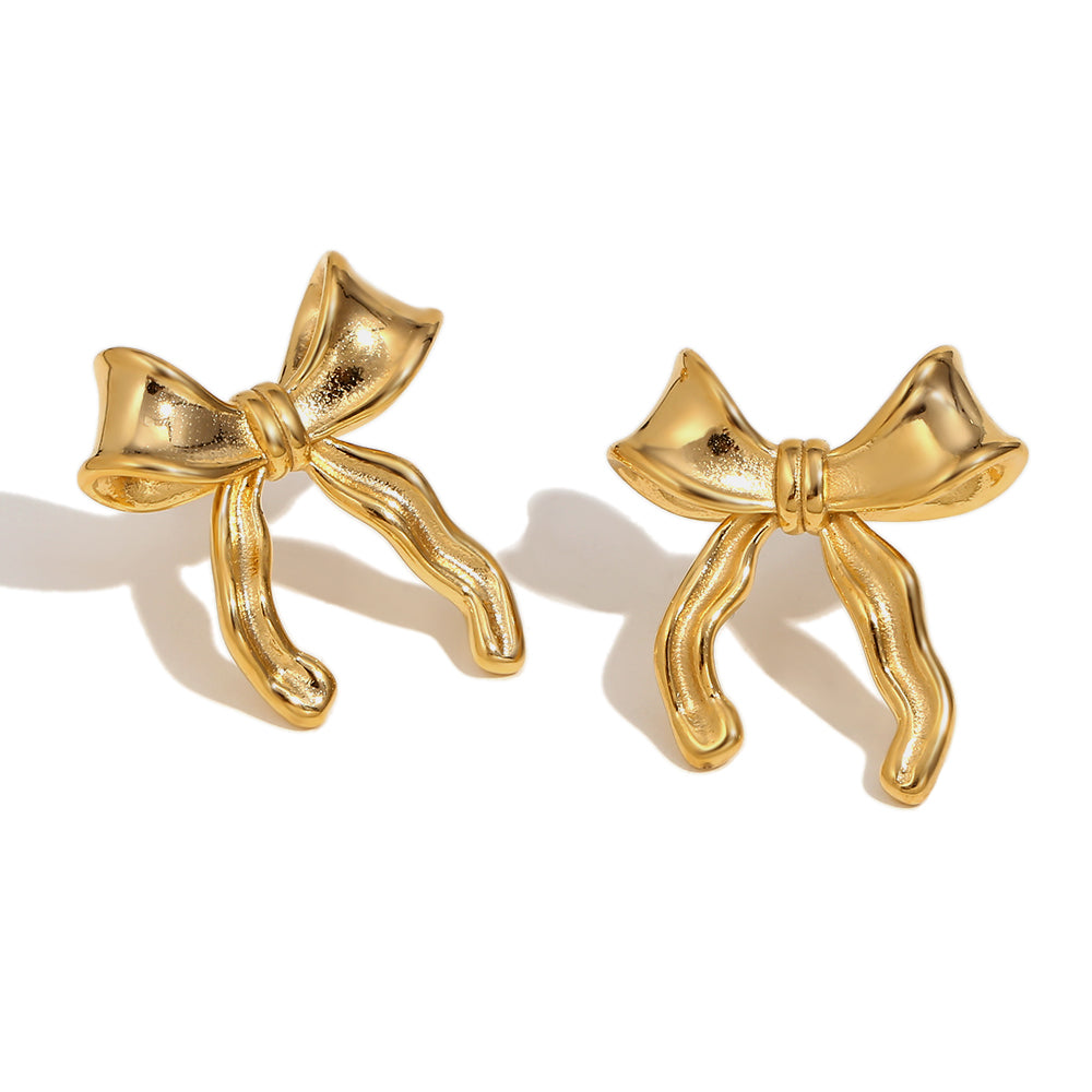 Gold bow-shaped earrings on a white background
