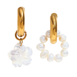 Gold hoop earrings with pearl accents on a white background
