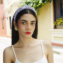 Load image into Gallery viewer, Close-up of a model showcasing an elegant headband and statement earrings.